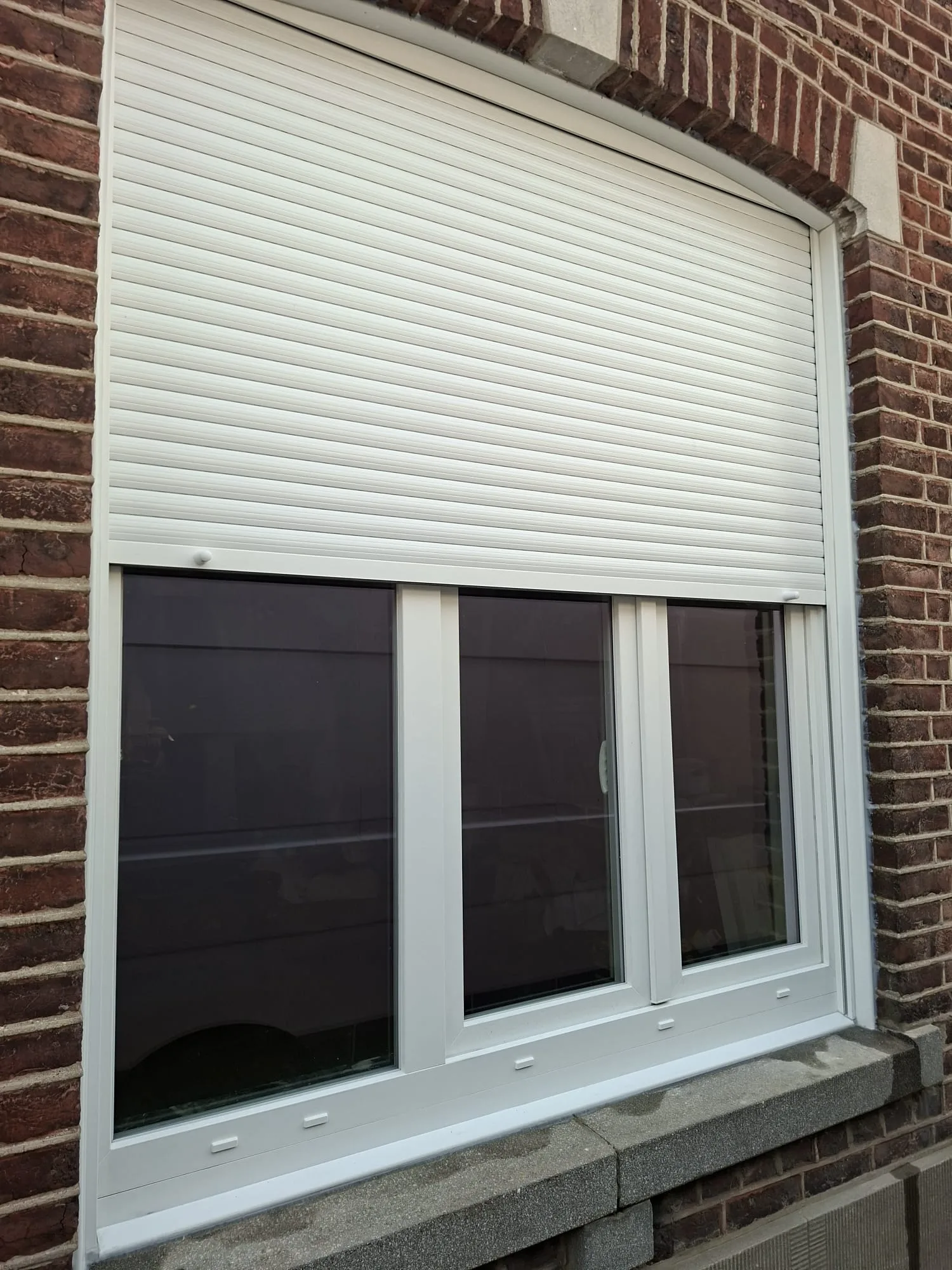 Large white PVC window with a roller shutter, box housed in the window reveal above the opening