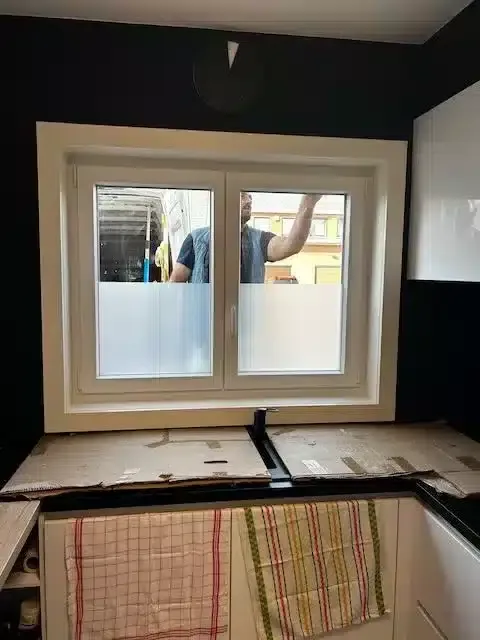 Modern white entrance door with glazed inserts installed in Meise — Pulsar Windows