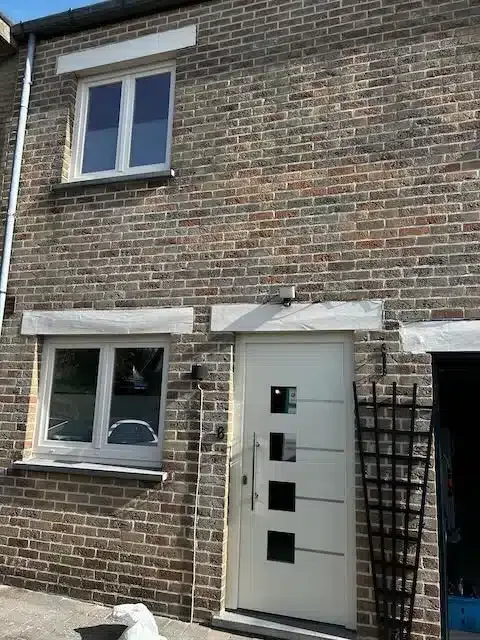 Modern white entrance door with glazed inserts installed in Meise — Pulsar Windows