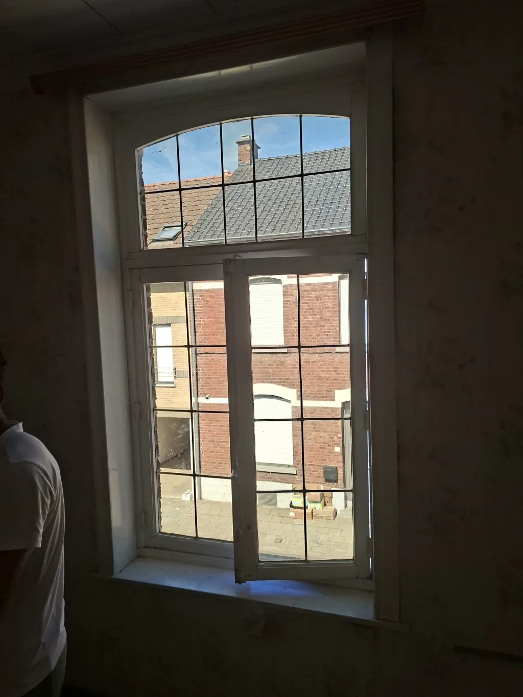 Before: old arched timber window with glazing bars