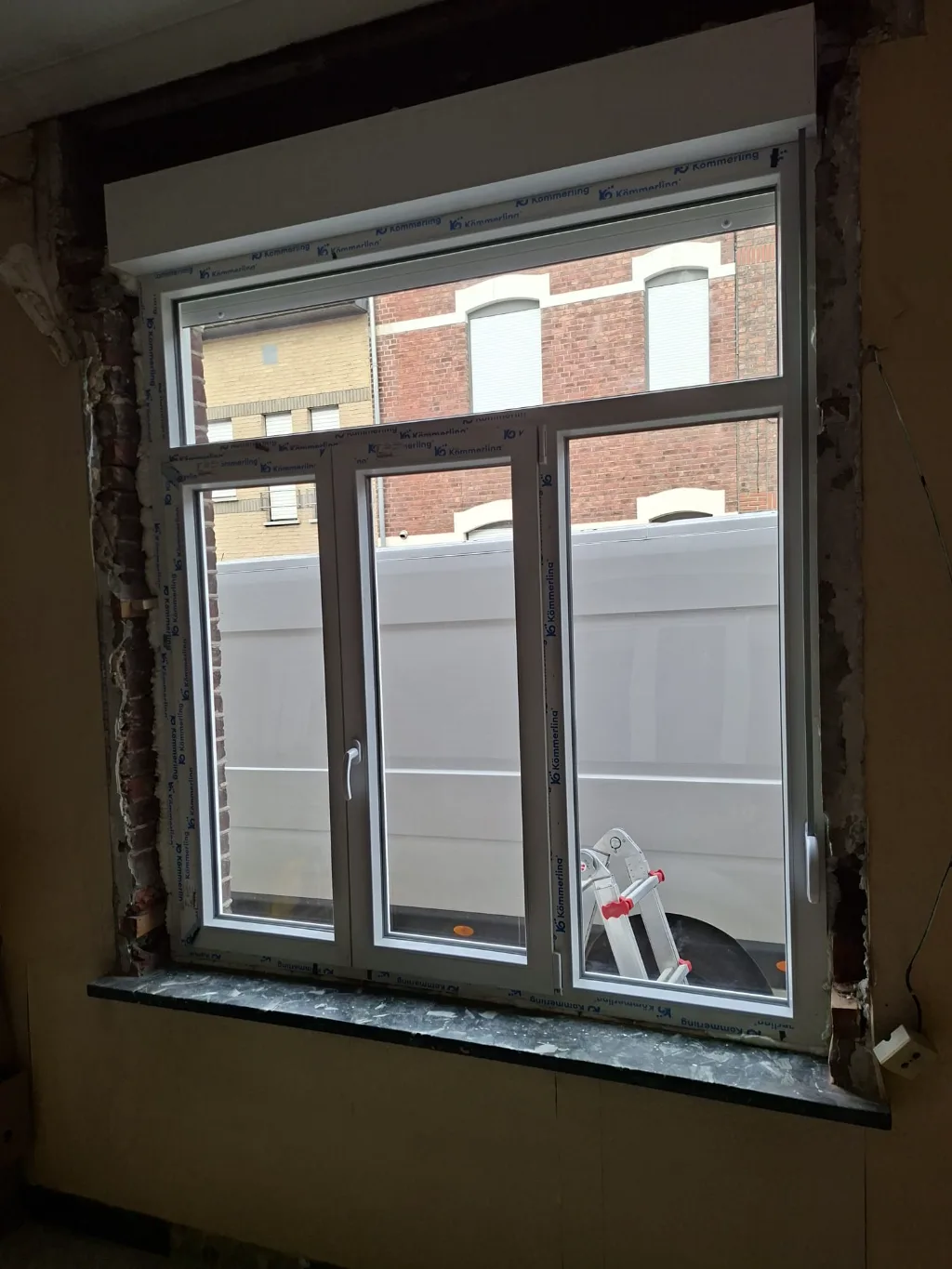 After: white PVC window with transom on the rear façade