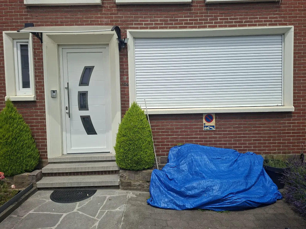 After: front façade with white PVC windows, new door and shutters