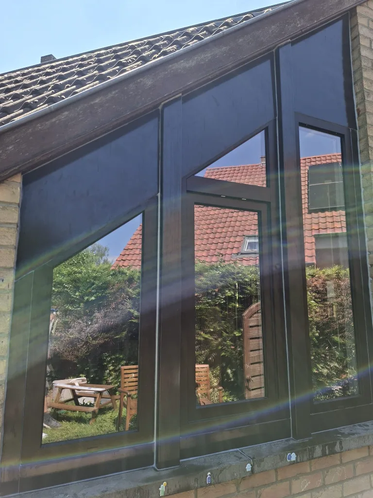 After: new triangular anthracite PVC window for the veranda